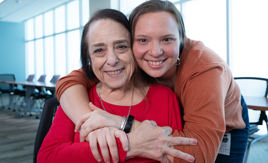 Jan, being pushed in her wheelchair by her daughter