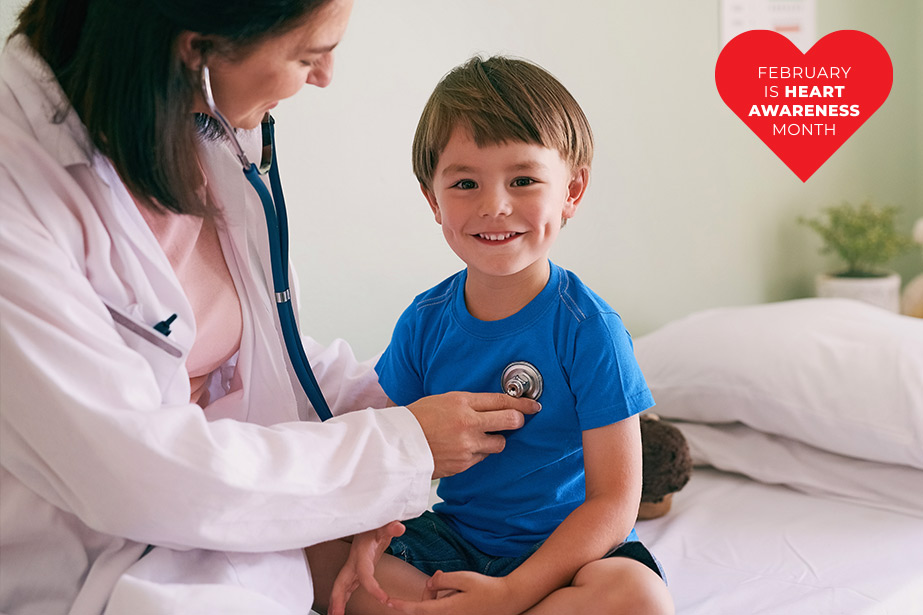 Doctor with stethoscope and child in hospital 