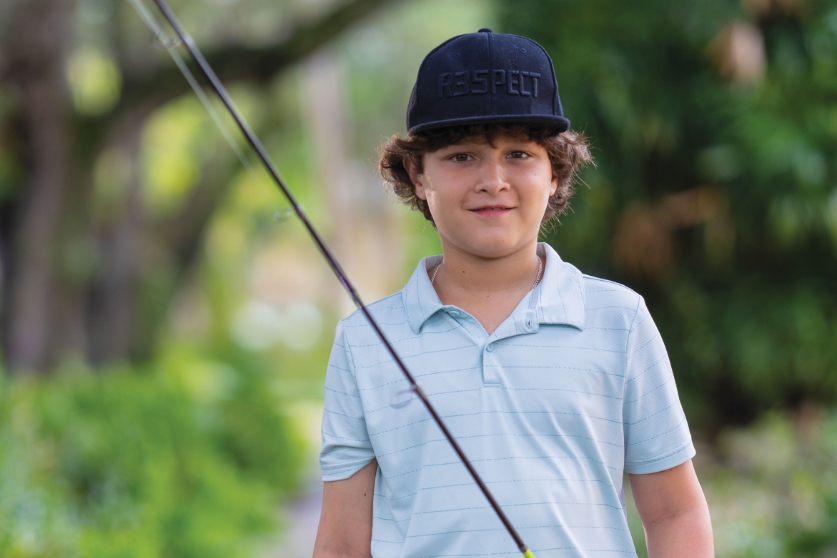 Fight the Unfair with a team that never stops fighting by your side. Jacob holding fishing pole.