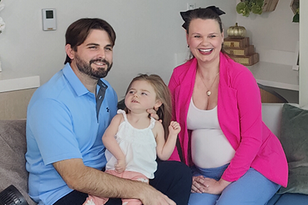 Ellia as a toddler with her parents, Sarah and Ryan