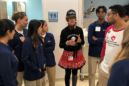 Lotsy Dotsy, Joe Ds resident clown, talking to teen volunteers