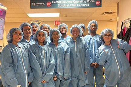 Teens participating in the Volunteer Explorer program in OR bunny suits