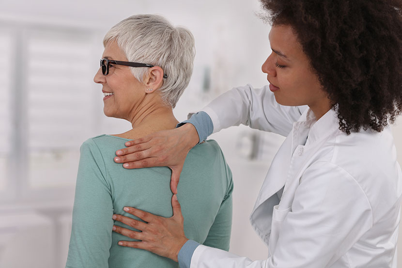 Doctor releasing pressure on patient's back
